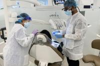 Faculty member and dental assistant treat a patient